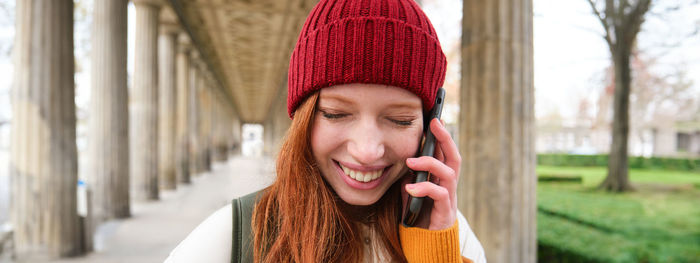 Portrait of young woman standing outdoors