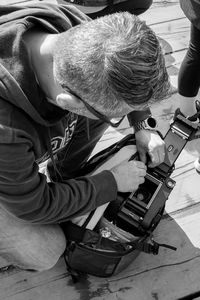 High angle view of man sitting on table