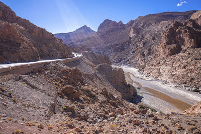 Beautiful winding road through mountains with river in summer