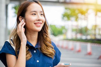 Portrait of young woman using mobile phone