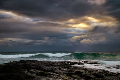 Scenic view of sea against cloudy sky