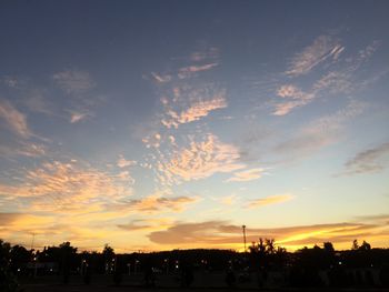 Silhouette city against sky during sunset