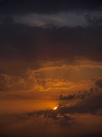 Scenic view of dramatic sky at sunset