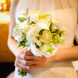 Midsection of woman holding bouquet