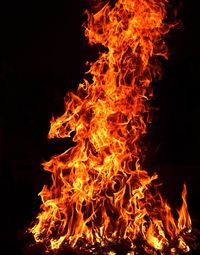 Close-up of fire on field against black background