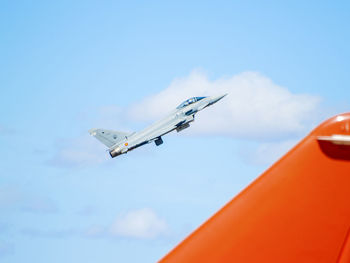 Low angle view of airplane flying in sky