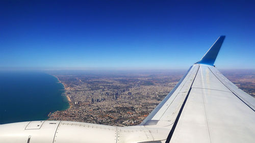 Aerial view of cityscape against clear blue sky