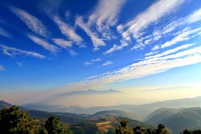 Scenic view of mountains against blue sky