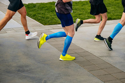 Low section of people walking on street