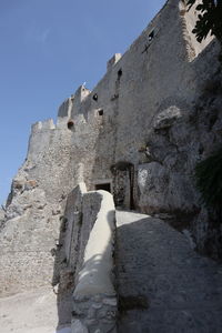 Low angle view of old ruin building against sky