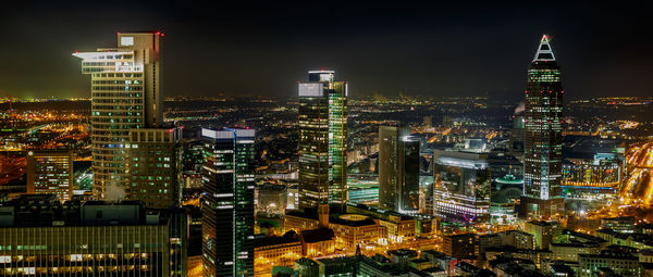 Panoramic view of city lit up at night