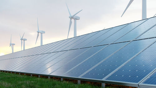 Solar panels and wind turbine on the sky background.3d rendering