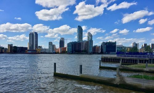 River in city against cloudy sky