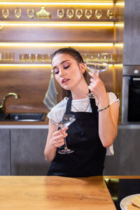 Young woman drinking wine at cafe