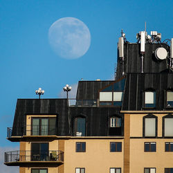 Low angle view of buildings against blue sky