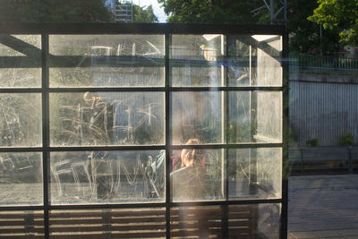 Man looking through window