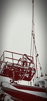 Low angle view of cranes against clear sky