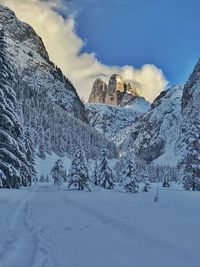 Scenic view of snow covered mountains against sky