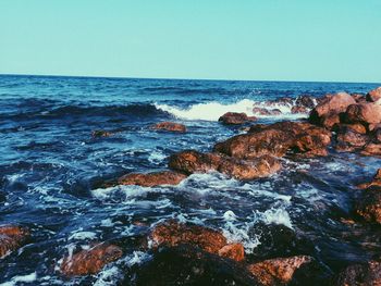 Scenic view of sea against clear blue sky