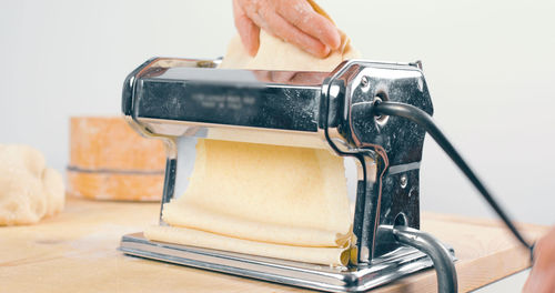 Homemade italian pasta with machine in the kitchen