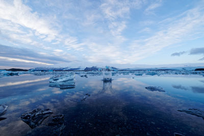 Scenic view of frozen lake against sky during winter