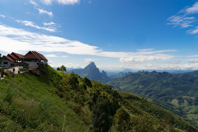 Scenic view of mountains and buildings against sky