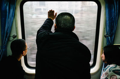 Rear view of people traveling in train