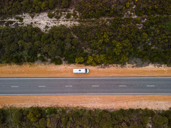 Car moving on road by trees