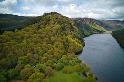 Aerial view of upper lake with lush foliage on surrounding hill. 