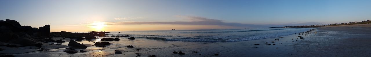 Panoramic view of beach against sky during sunset