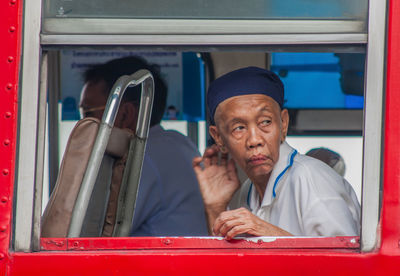 Portrait of man sitting in bus