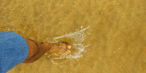 Close-up of man splashing water in sea