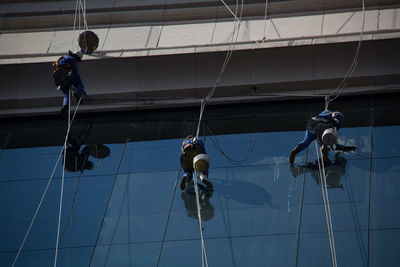 Low angle view of men working on rope