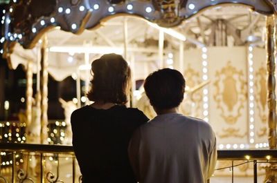 Rear view of two people at amusement park