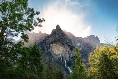 Scenic view of mountains and trees against sky