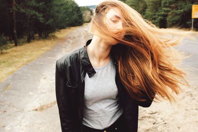 Portrait of young woman tossing hair