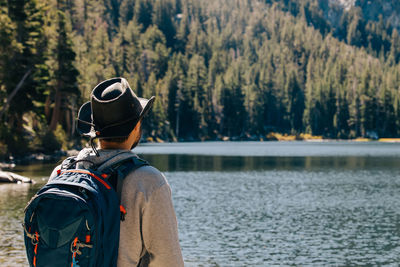 Rear view of man standing in lake