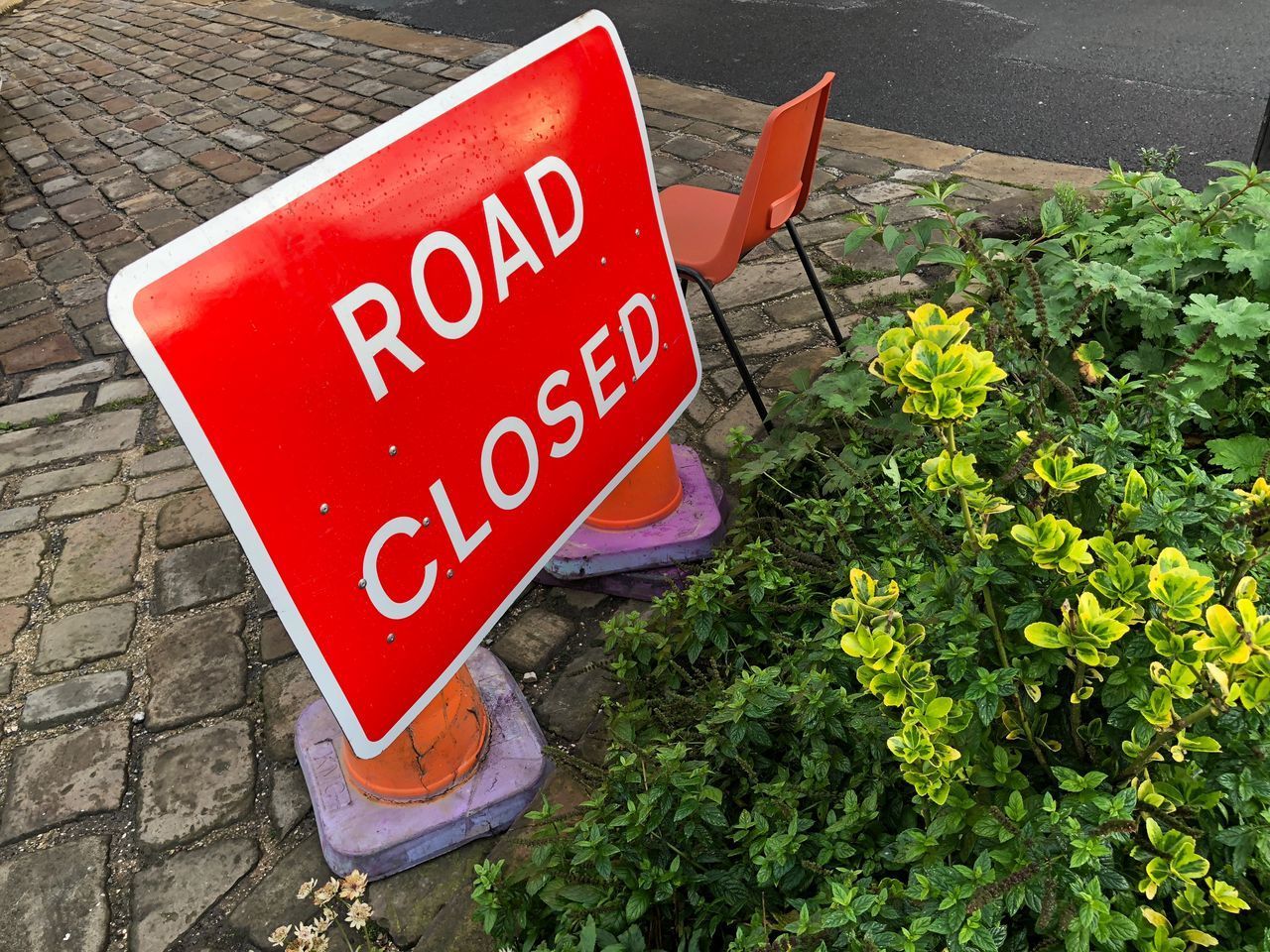 HIGH ANGLE VIEW OF SIGN BOARD ON FOOTPATH