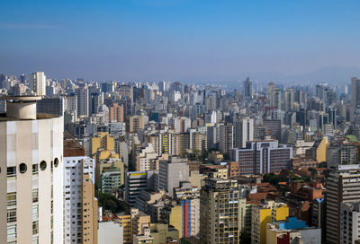 High angle view of modern buildings in city against sky