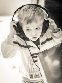 High angle view of boy listening music in store