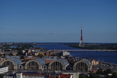 Sailboats in sea against buildings in city