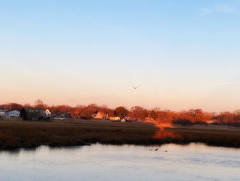 Scenic view of lake against sky during sunset