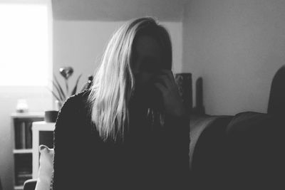 Portrait of woman sitting at home