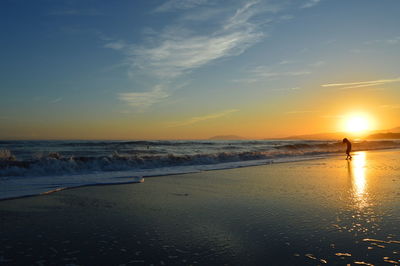 Scenic view of beach against sky during sunset