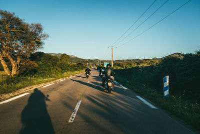 People on street against clear sky