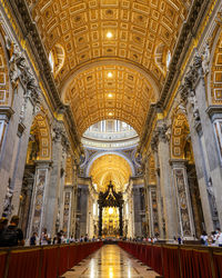 Low angle view of illuminated ceiling of st peter's basilica 