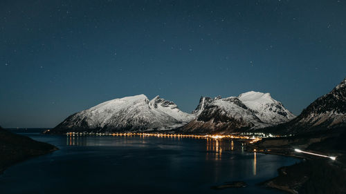 Scenic view of snowcapped mountains against sky at night