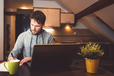 Young man using laptop at home