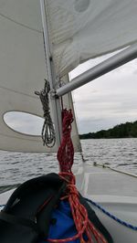 Sailboat tied to boat sailing in sea