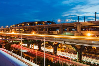 Train on bridge in city against sky